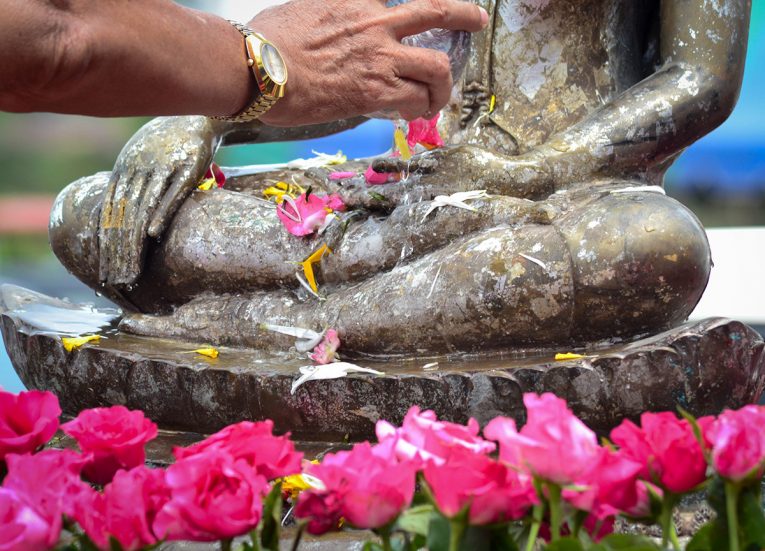 Pouring Water on Buddha Statue Ceremony for Songkran Festival in Thailand