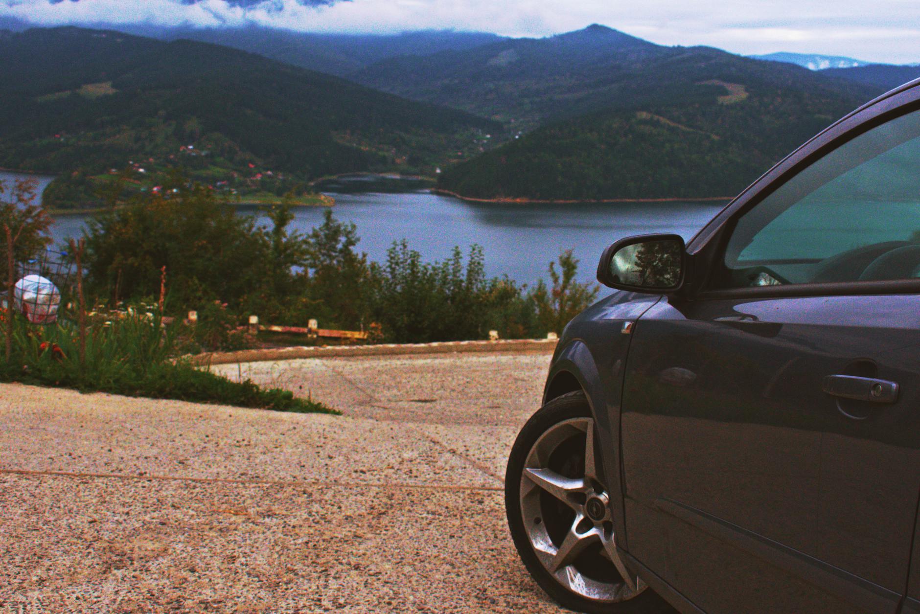 black car parked near trees